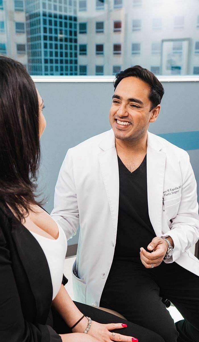 Elk Grove Village plastic surgeon, Dr. Sameer Kapadia, consulting with a patient