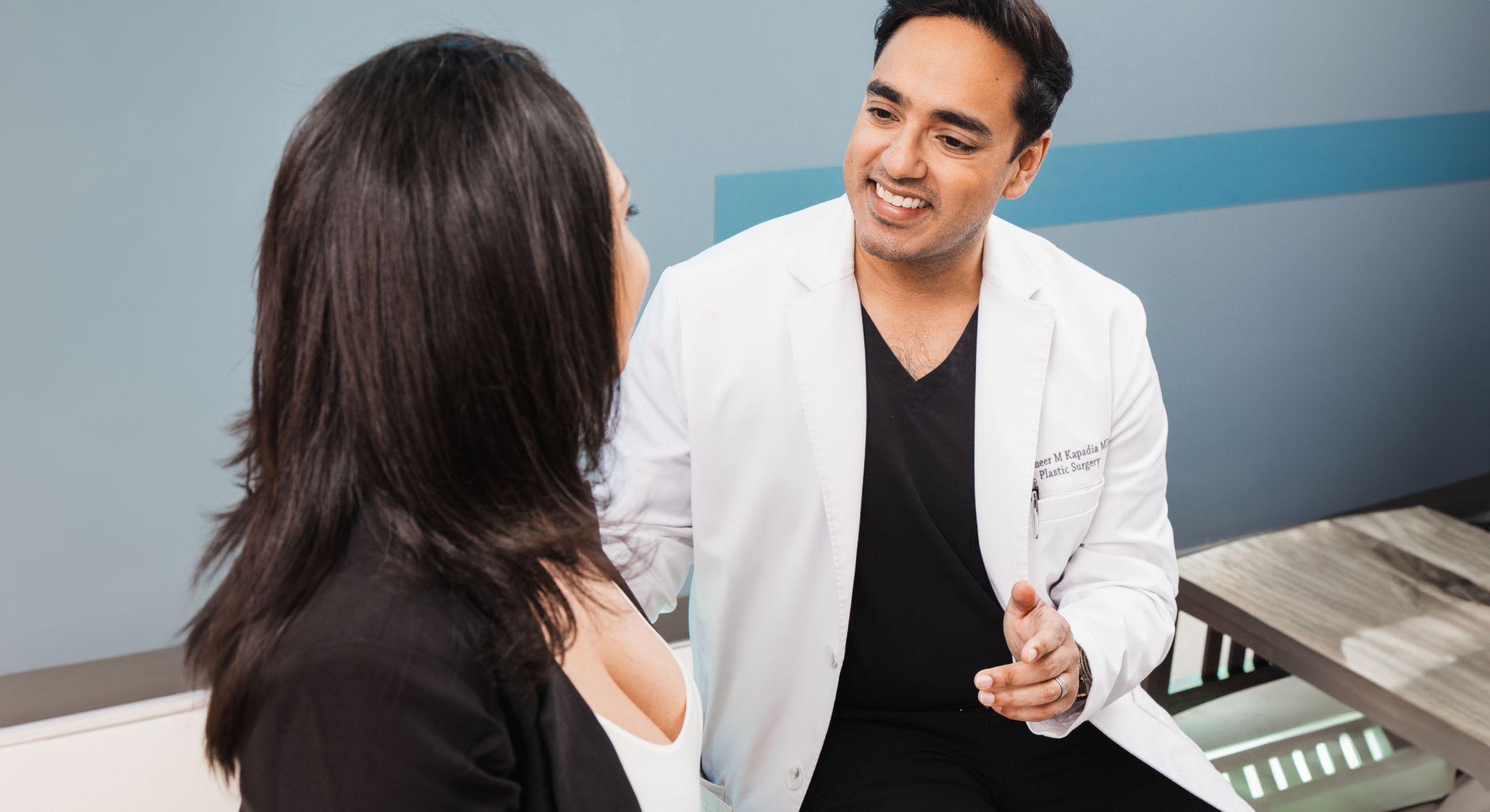 Elk Grove Village breast reduction surgeon, Dr. Kapadia, meeting with a patient